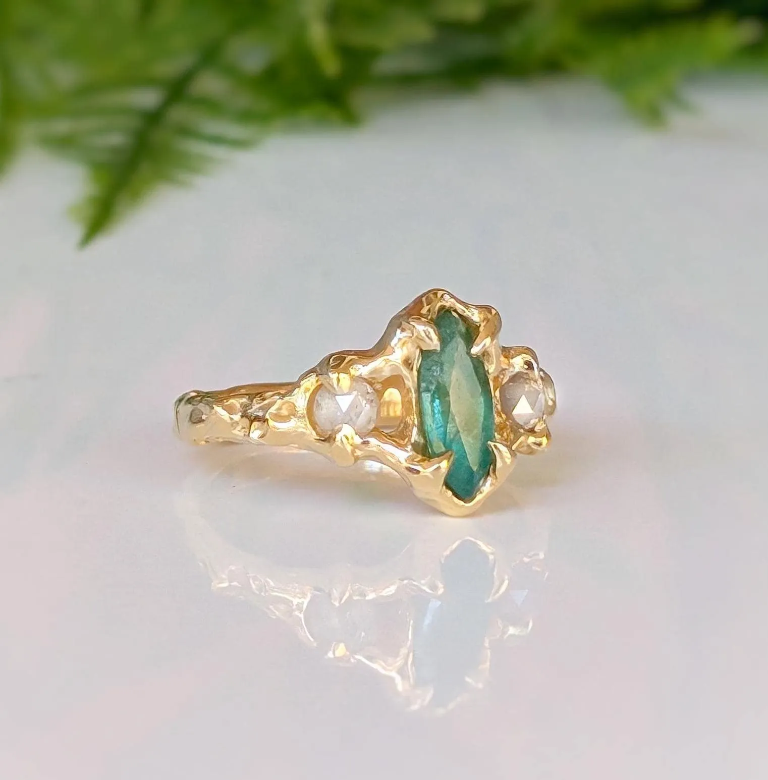 Emerald and diamond engagement ring